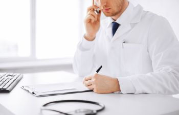 Doctor Writing a Diagnosis