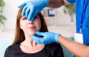 A woman during a saddle nose repair consultation with a plastic surgeon.