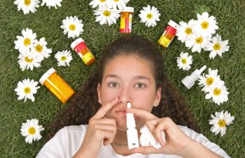 Woman using nose spray.