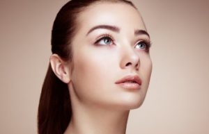 young attractive woman with big blue eyes looks up