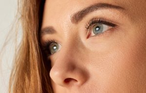 Close-up image of beautiful female face, eyes, brows and nose. Brows and lashes lamination. Concept of natural beauty, skin care, health, plastic surgery, cosmetics, facial treatment, cosmetology