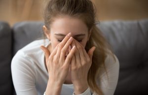 Close up thoughtful woman with closed eyes covered face in hands, feeling pain, having problem with relationships or health, headache, upset tired girl worried about future, making hard decision